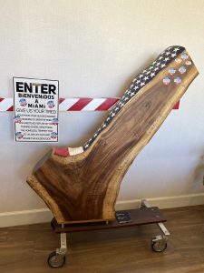 Image: A wooden check mark carving installation where voters can place their voting stickers