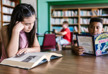 Library Card Sign-Up Month: So Much to Check Out Image: Children read books at a local library