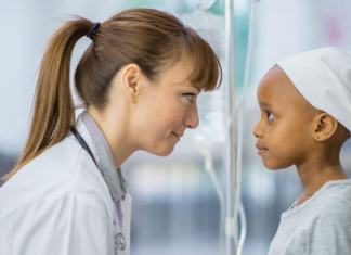 Childhood Cancer Awareness: How is Nicklaus Children’s Hospital bringing health and hope Image: A doctor kneels down to eye level with a pediatric patient