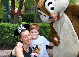 Summer Theme Park Survival Basics: 12 Helpful Tips for Your Trip Image: A mother and son pose for a photo with Chip and Dale