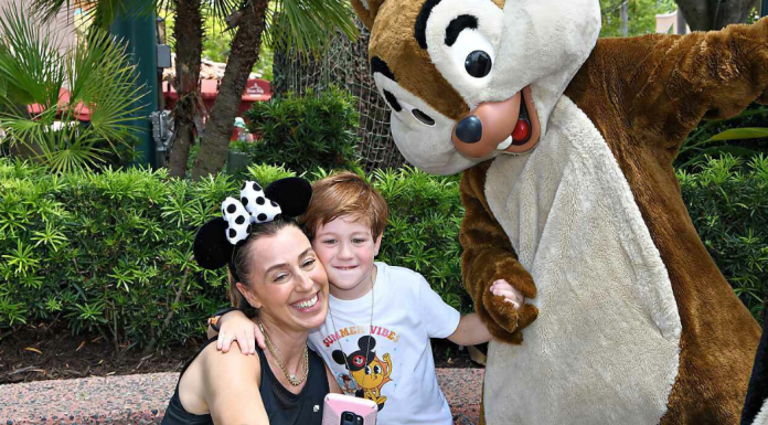 Image: A mother and son pose for a photo with Chip and Dale