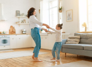 Image: A mom and daughter dance in the living room