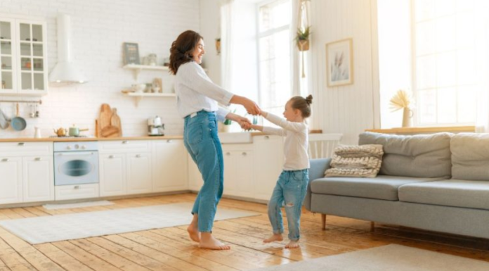 Image: A mom and daughter dance in the living room