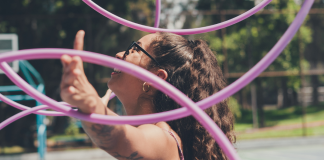 Image: A woman juggles several hula hoops