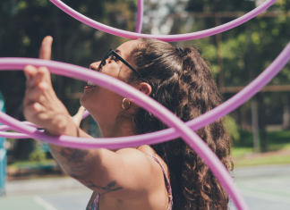 Image: A woman juggles several hula hoops