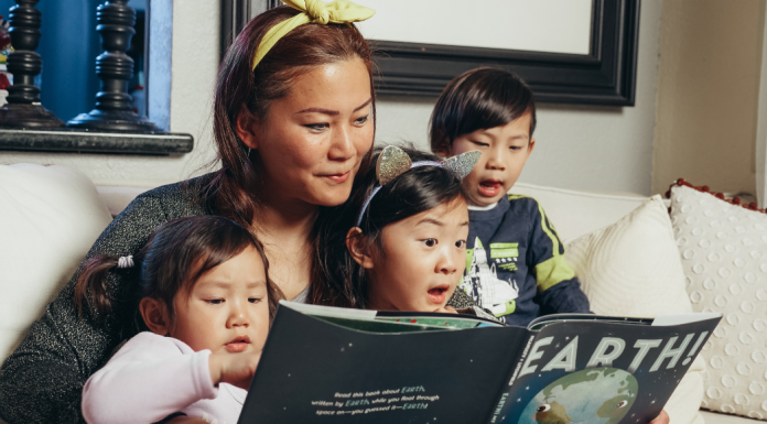 Slowing Down as a Parent: The Importance of Seizing the Moments Image: A woman reads a book with her children