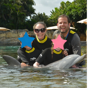 Image: Ilana's family enjoys a swim with a dolphin at Discovery Cove Orlando
