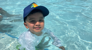 Image: A little boy plays in a swimming pool