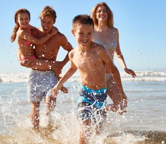 Image: A family playing in the surf at the beach