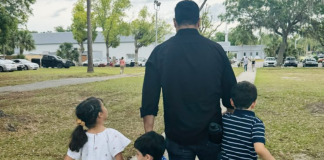 Image: A dad walking with his 3 children