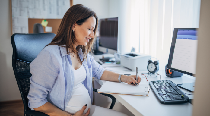 Career Transitions: 10 Tips for Preparing for Maternity Leave Image: An expectant mother sits at her desk at work