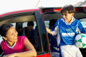 Image: A mom drops her son off for sports practice