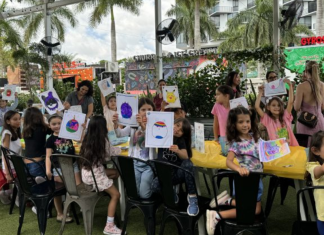 Comic Kids: A Purposeful Morning of Art, Fun & Giving Back Image: Children at Miami Mom Collective's Comic Kids event hold up pictures of their squish mallows