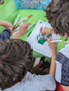 Image: Kids work together to design and color a squish mallow