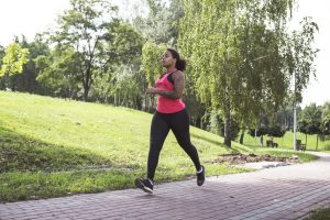 Image: A woman power walking on a walking path
