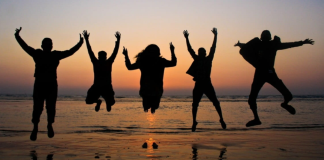 Image: A group of friends jumping in the air for a photo