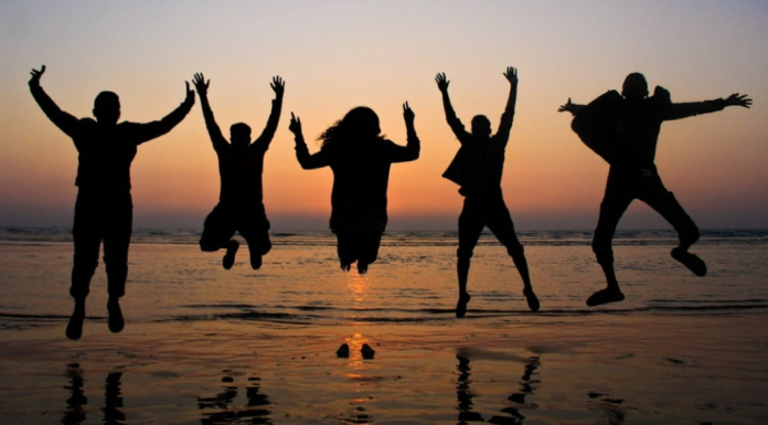 Friends: The Importance of Friendships in Motherhood Image: A group of friends jumping in the air for a photo