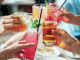 Image: A group of people doing cheers with alcoholic beverages