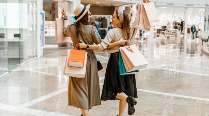Fashion Forward Mom: How to Keep Up With Stylish Trends Image: 2 women carrying shopping bags while they shop together