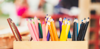 Image: A wooden box of art supplies on a table