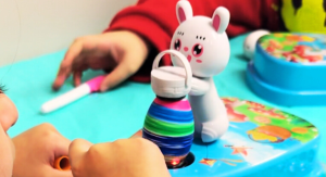 Image: Children demonstrating the egg spinner Easter egg decorating tool