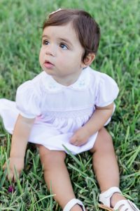 Image: A toddler sitting in the grass
