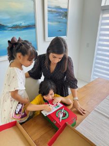 Image: Valerie and her kids assembling and labeling a shoebox for an initiative of Samaritan's Purse