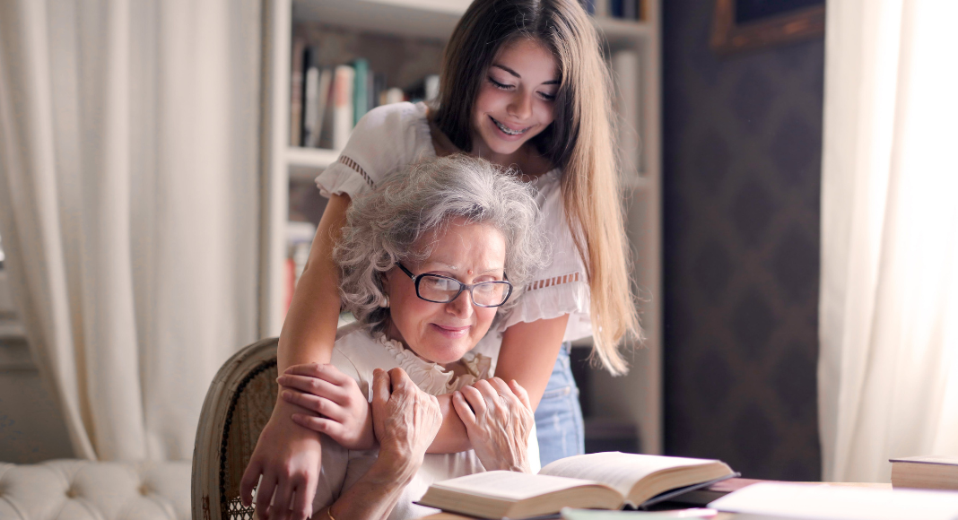 Image: A child hugging her grandmother.