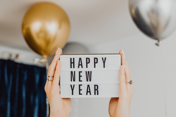 Image: A Happy New Year sign with silver and gold baloons