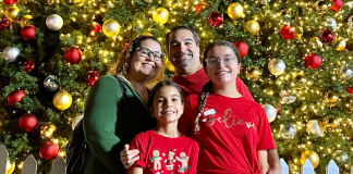 Christmas Light Displays: A List of the Must-See Places in Miami Image: A family poses for a photo in front of a Christmas Tree at Christmas Wonderland