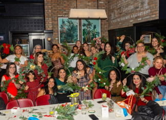 Image: Local moms pose for a group photo at our annual Deck the Walls event