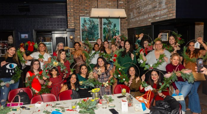 Image: Local moms pose for a group photo at our annual Deck the Walls event