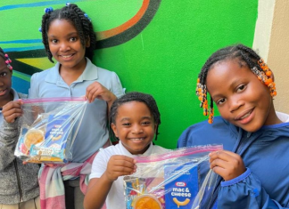 Holiday Snack Pack Project: Help a Child on School Winter Break Image: Children holding snack packs assembled and distributed by Branches, a local nonprofit in Miami-Dade