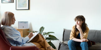 Image: A therapist sitting with a client