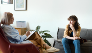 Image: A therapist sitting with a client