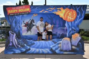 Image: A family poses for a photo op at Disney