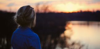 Image: A woman looks out on a lake