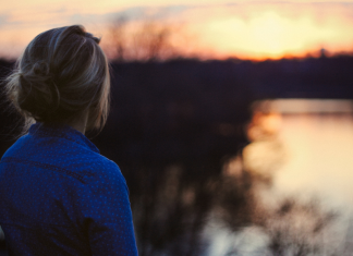 Image: A woman looks out on a lake