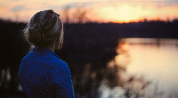 Image: A woman looks out on a lake