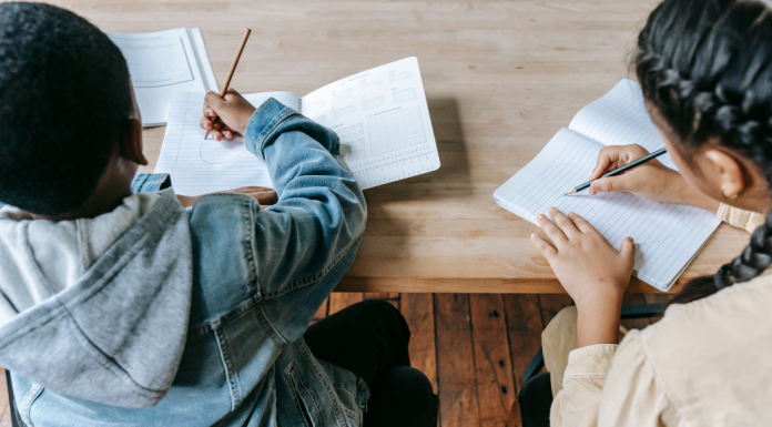 Back-to-School Prep & Routines | MOM STRONG Image: Two classmates hard at work at school
