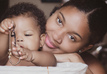 Black Breastfeeding Week: Relevant Resources + Local Support Image: A Black mother smiles while her infant plays