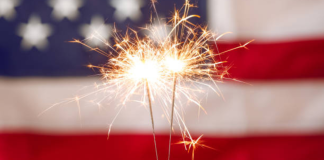 Image: Sparkler fireworks with an American flag in the background