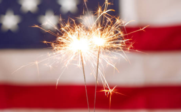 Image: Sparkler fireworks with an American flag in the background