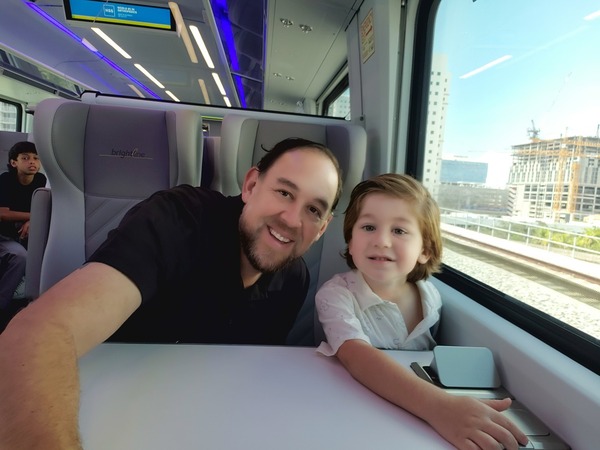 Image: Sandra's husband and son riding on Brightline