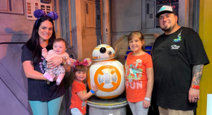 Image: A family poses for a photo with BB-8