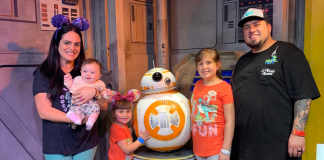 Image: A family poses for a photo with BB-8