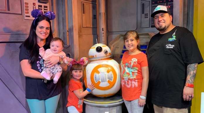 May the 4th be With You: 4 Fun Crafts to Make With Your Kids Image: A family poses for a photo with BB-8