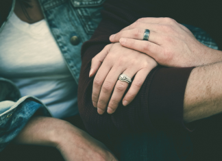 Image: A married couple sitting together, arm in arm