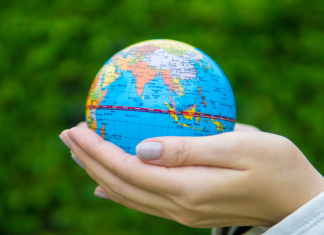 Image: Hands holding a miniature globe