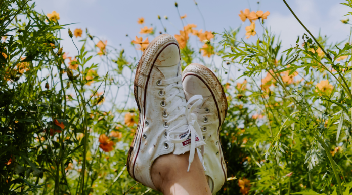 Spring Cleaning for Your Mind & Your Body | MOM STRONG Image: Crossed ankles in a field of flowers